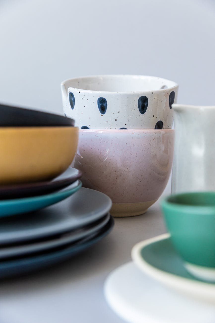 mugs by stacks of plates